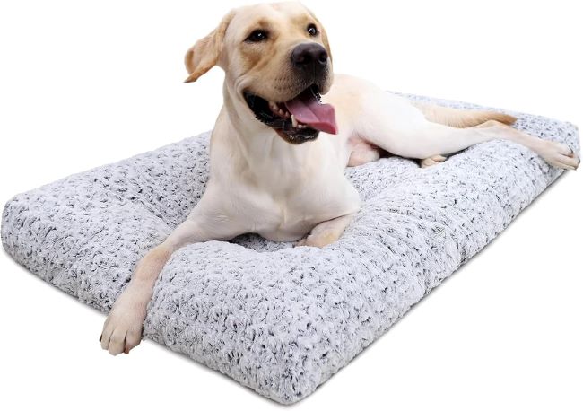 A large gray KSIIA deluxe plush washable dog bed placed inside a cozy crate.